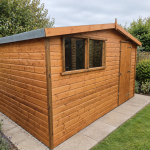Rosedale 12 x 8 golden shiplap shed installed in a garden